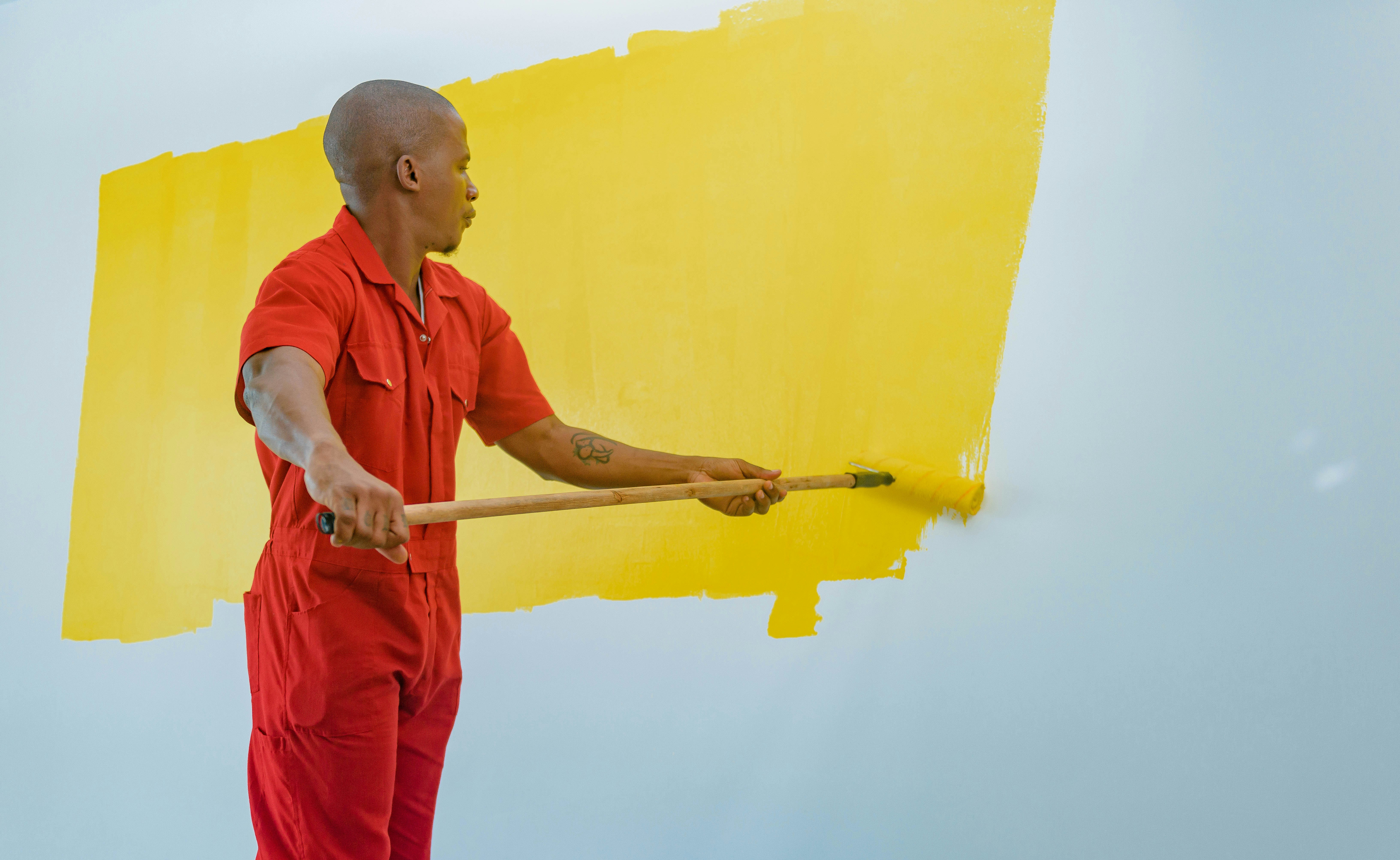Painter rolling fresh paint on a residential interior wall